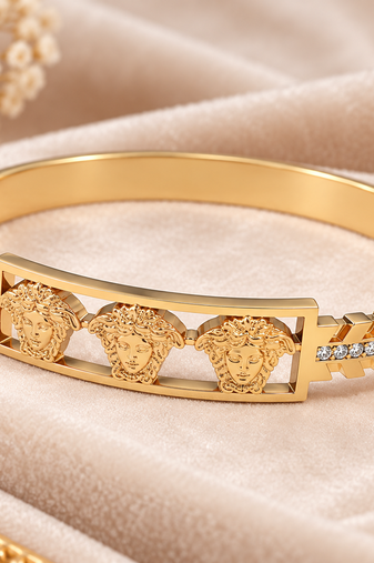 Gold-tone medusa bangle bracelet with crystal accents