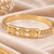 Gold-tone medusa bangle bracelet with crystal accents