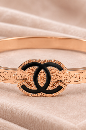Rose gold bangle bracelet with black enamel cc motif