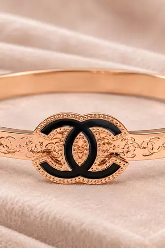 Rose gold bangle bracelet with black enamel cc motif