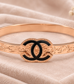 Rose gold bangle bracelet with black enamel cc motif