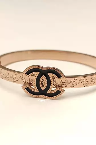 Rose gold bangle bracelet with black enamel cc motif