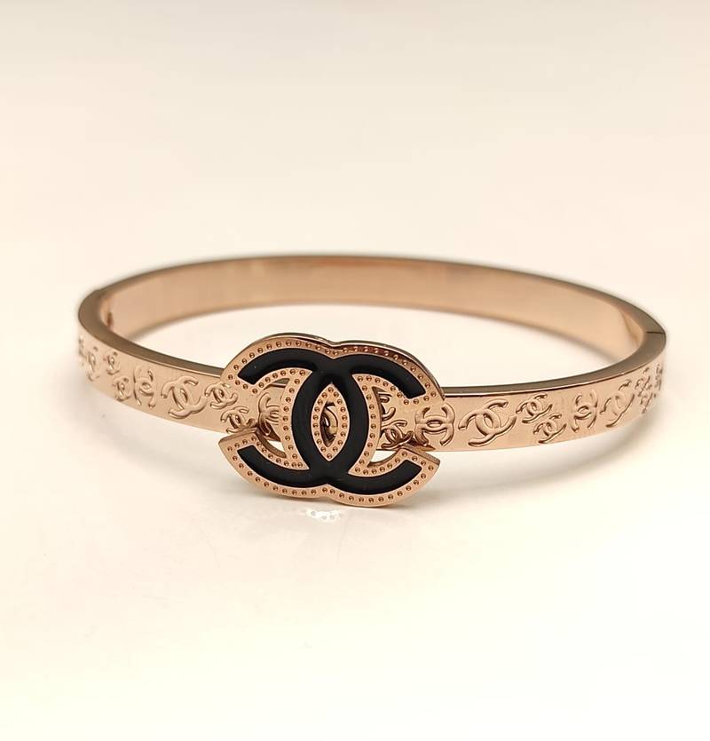 Rose gold bangle bracelet with black enamel cc motif
