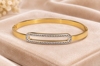 Gold-tone bangle bracelet with crystal oval centerpiece 1