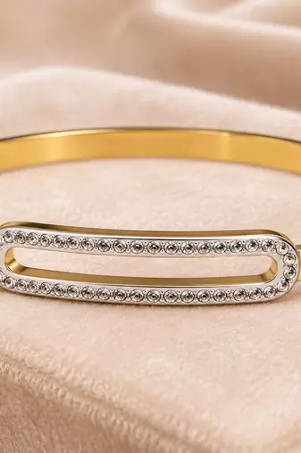 Gold-tone bangle bracelet with crystal oval centerpiece