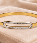 Gold-tone bangle bracelet with crystal oval centerpiece