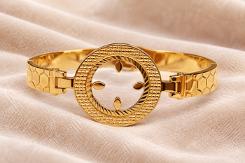 Gold-toned bangle bracelet with circular medallion & floral cutout 1