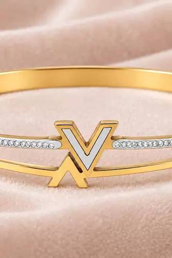 Gold-tone bangle bracelet with v logo charm and crystal accents