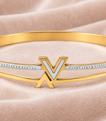 Gold-tone bangle bracelet with v logo charm and crystal accents