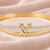 Gold-tone bangle bracelet with v logo charm and crystal accents
