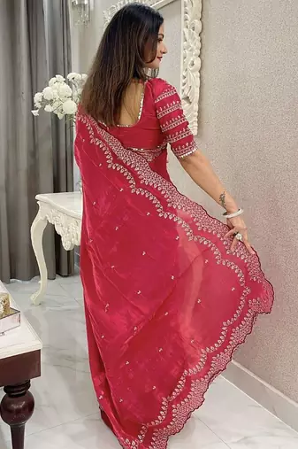 red embroidered saree with blouse piece