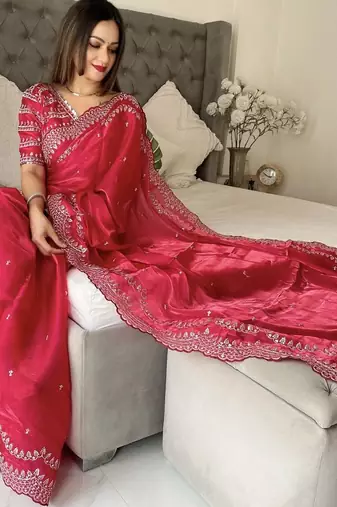 red embroidered saree with blouse piece