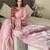 pink women ethnic motifs embroidered saree