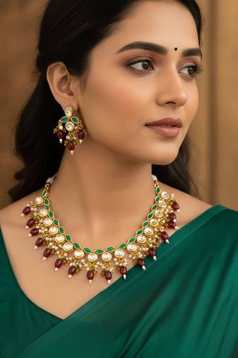 Gold plated kundan necklace set with green meenakari, red beads and crystal accents with earrings