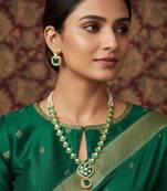 Gold-plated kundan necklace set with green meenakari pendant and pearl chain and earrings