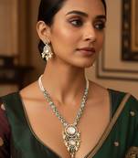 Silver-plated kundan necklace set with green stones and pearl drops