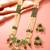 Gold plated long pearl necklace set with green stone pendant and earrings