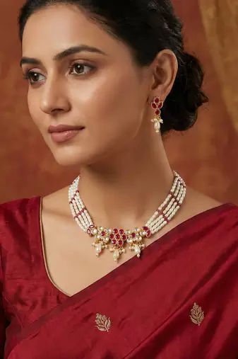 Gold plated multi-strand pearl necklace with red stone detail