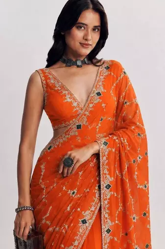 Orange ethnic motifs embroidered satin heavy work saree