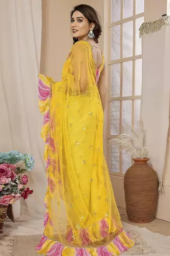 Yellow embellished mirror work net ruffle saree with blouse piece