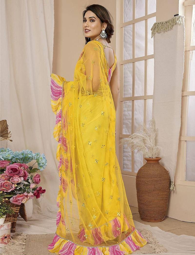 Yellow embellished mirror work net ruffle saree with blouse piece