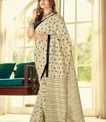 Cream ethnic motifs printed saree