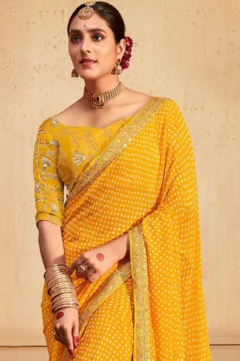 Yellow printed sequinned poly georgette bandhani saree