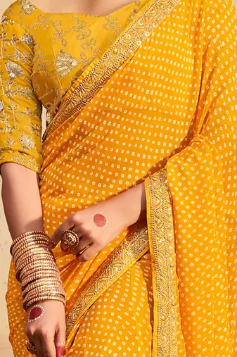Yellow printed sequinned poly georgette bandhani saree