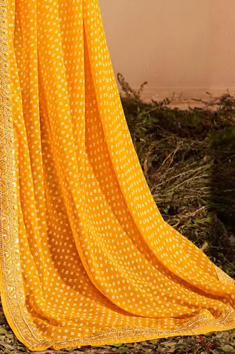 Yellow printed sequinned poly georgette bandhani saree
