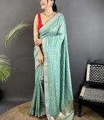 Teal ethnic motifs sequinned silk blend bandhani saree