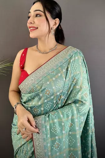 Teal ethnic motifs sequinned silk blend bandhani saree
