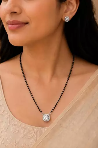 Silver toned round solitaire black beaded mangalsutra with earrings