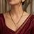 Women's golden toned floral mangalsutra & stud earring jewelry set