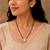 Round solitaire design black beaded mangalsutra with stud earrings