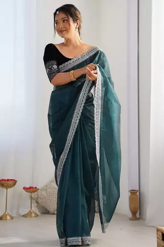 Teal sequinned net saree with blouse piece