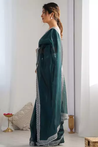 Teal sequinned net saree with blouse piece