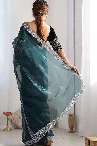 Teal sequinned net saree with blouse piece
