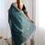 Teal sequinned net saree with blouse piece