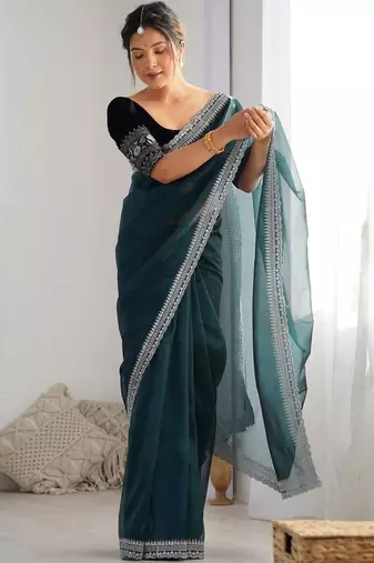 Teal sequinned net saree with blouse piece