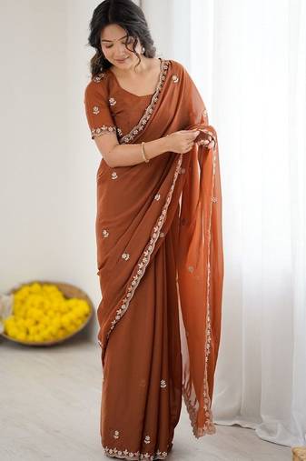 Rust embellished embroidered pure georgette heavy work saree