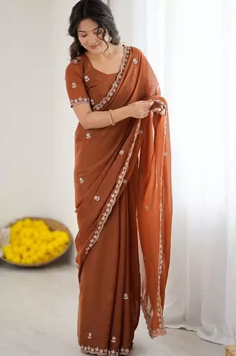 Rust embellished embroidered pure georgette heavy work saree