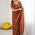 Rust embellished embroidered pure georgette heavy work saree