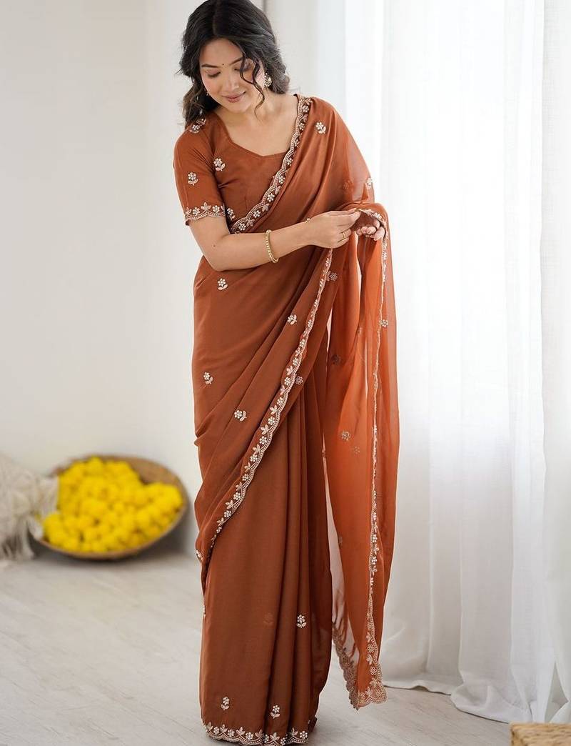 Rust embellished embroidered pure georgette heavy work saree