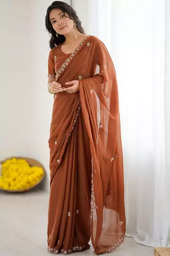 Rust embellished embroidered pure georgette heavy work saree