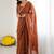 Rust embellished embroidered pure georgette heavy work saree