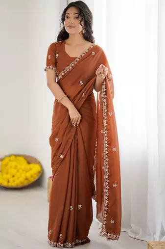 Rust embellished embroidered pure georgette heavy work saree