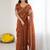 Rust embellished embroidered pure georgette heavy work saree