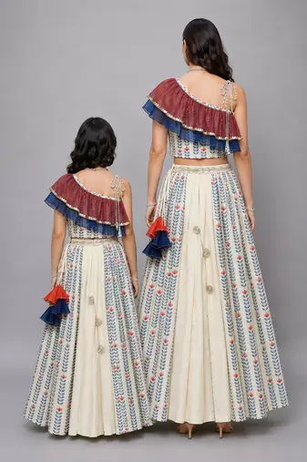 Mother daughter off white printed off shoulder ruffled blouse lehenga set
