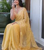 Yellow sequinned silk cotton saree