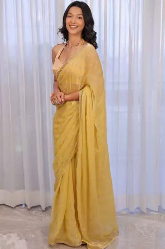 Yellow sequinned silk cotton saree
